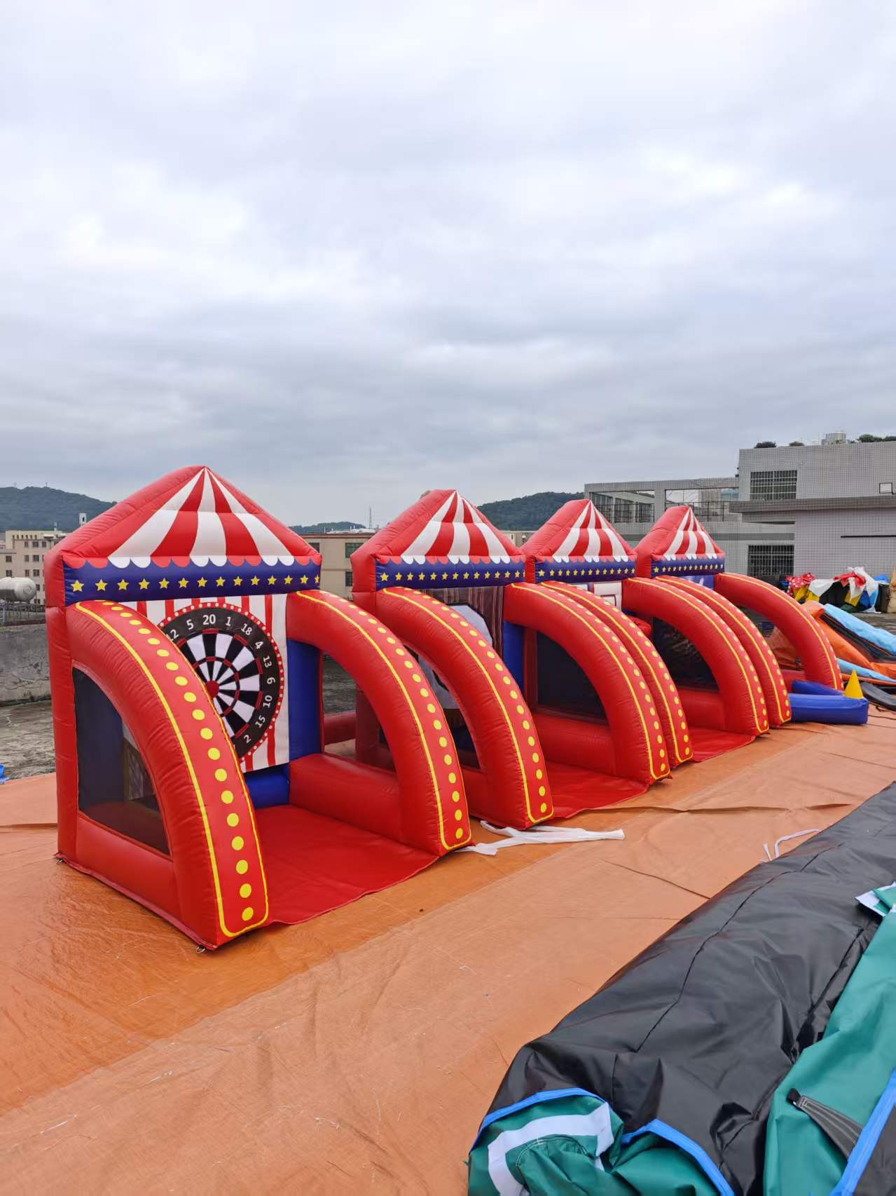 Red inflatable dartboard challenge course with several play lanes
