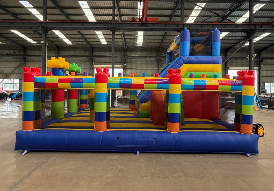 Front view of the rainbow obstacle castle with slide